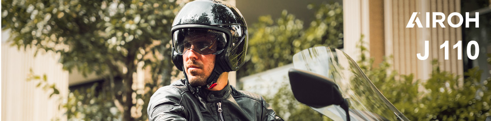 Airoh Helme - Mann auf Motorrad in urbaner Gegend mit Airoh J 110 Helm